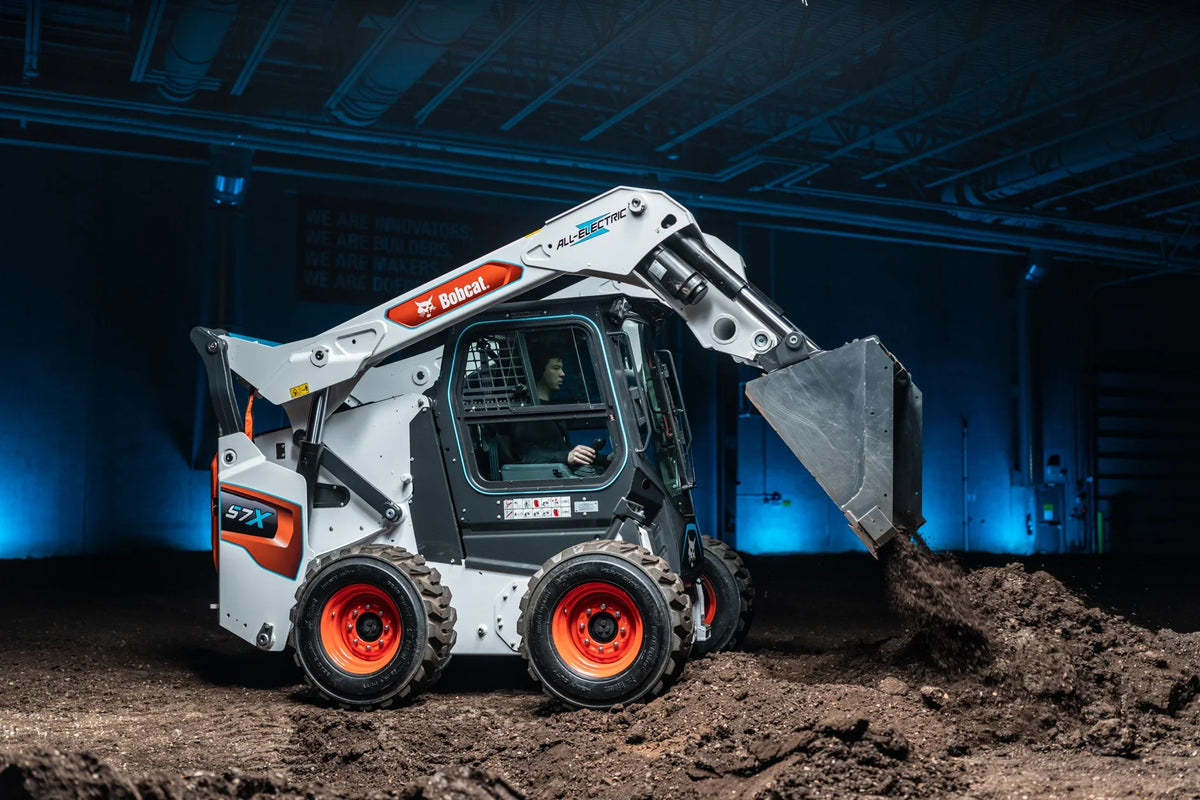 A Bobcat S7X Skid Steer moving dirt