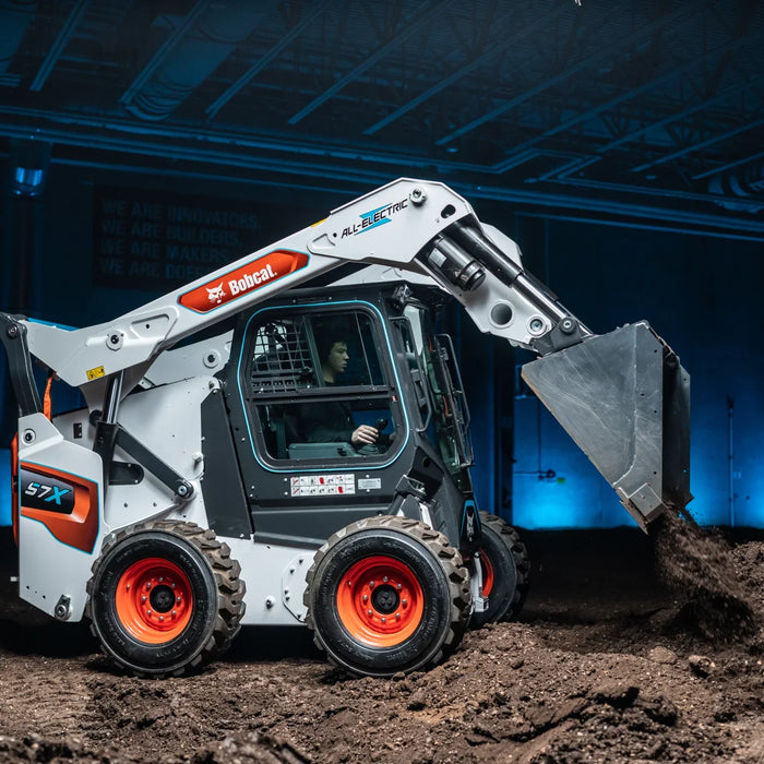 A Bobcat S7X Skid Steer moving dirt